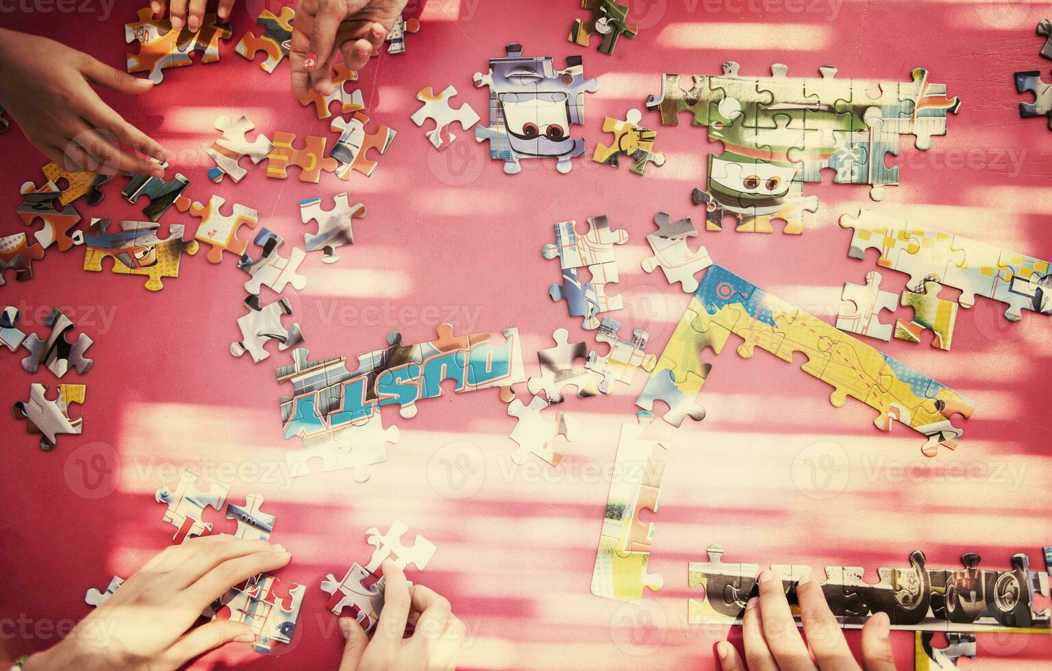 top view of kids hands playing with puzzles photo