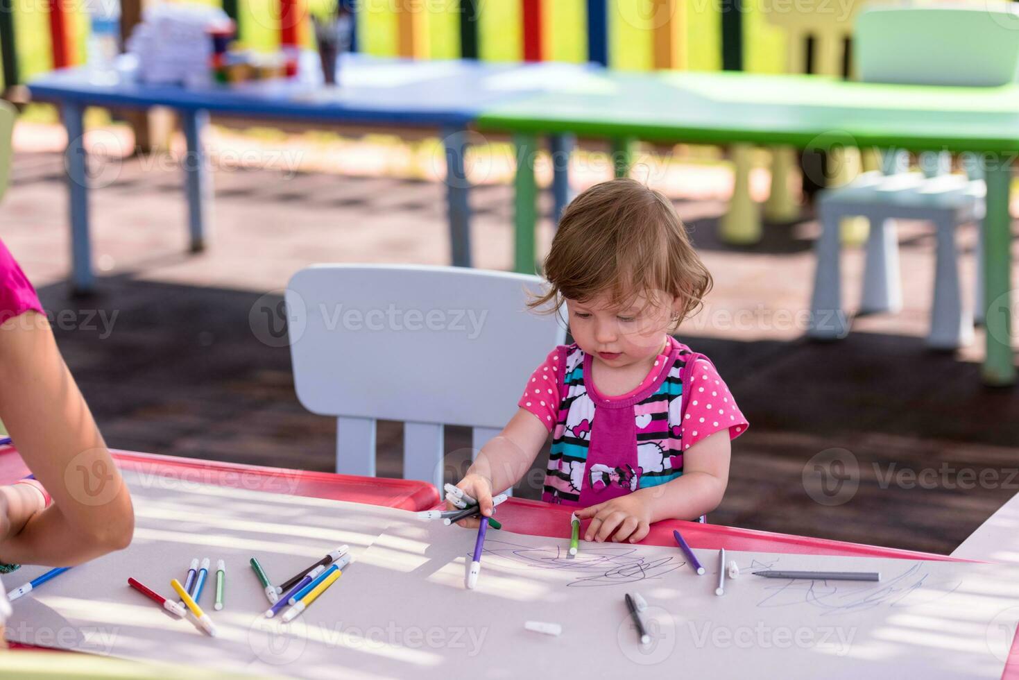 little girl drawing a colorful pictures photo