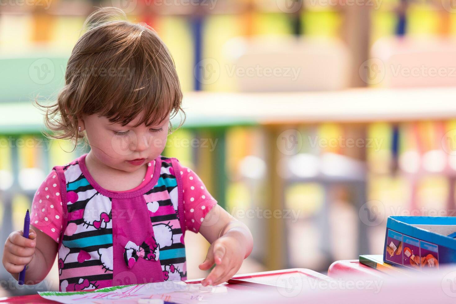 little girl drawing a colorful pictures photo