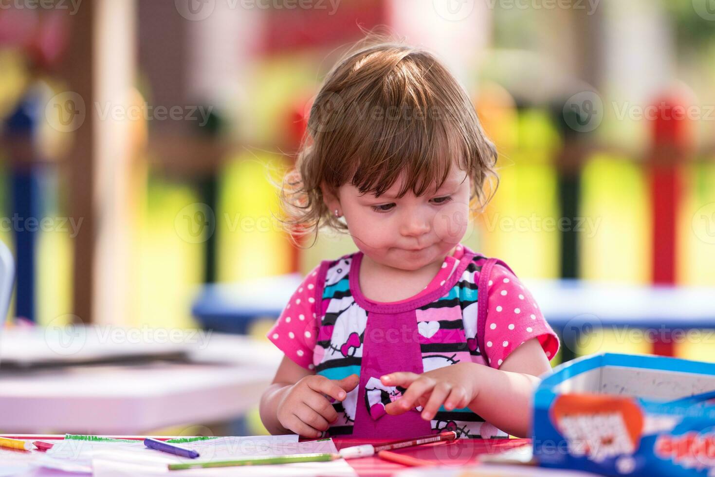 little girl drawing a colorful pictures photo