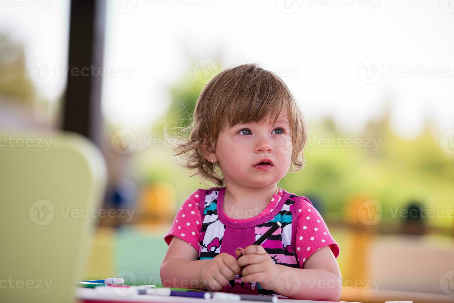 little girl drawing a colorful pictures photo