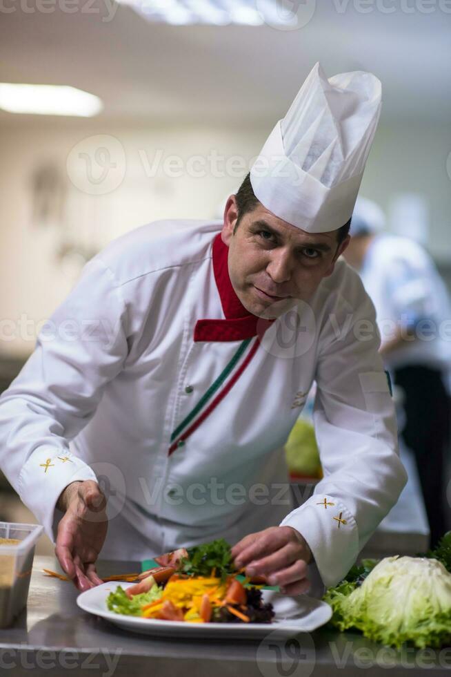 chef serving vegetable salad photo