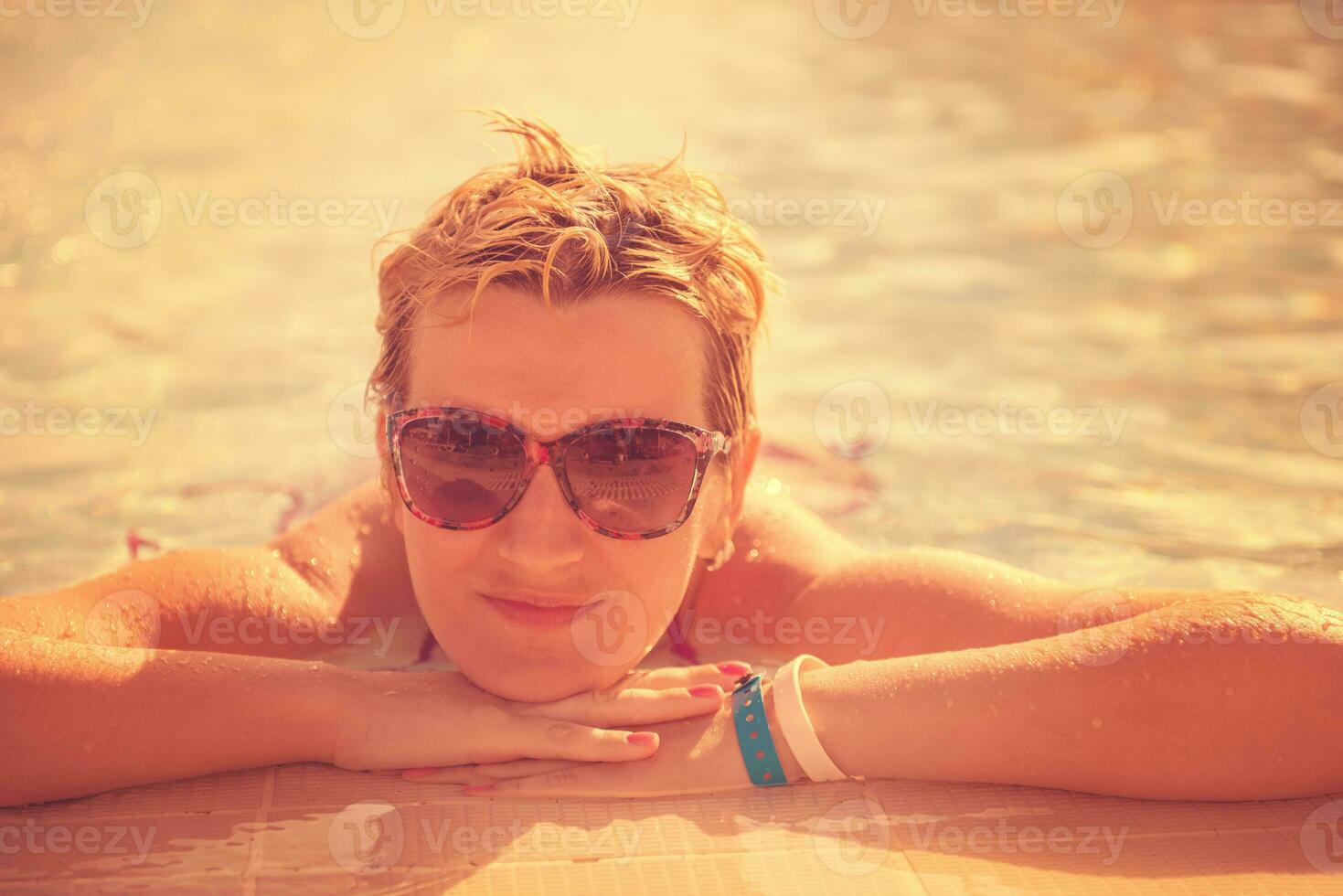 woman enjoying holidays in the swimming pool photo
