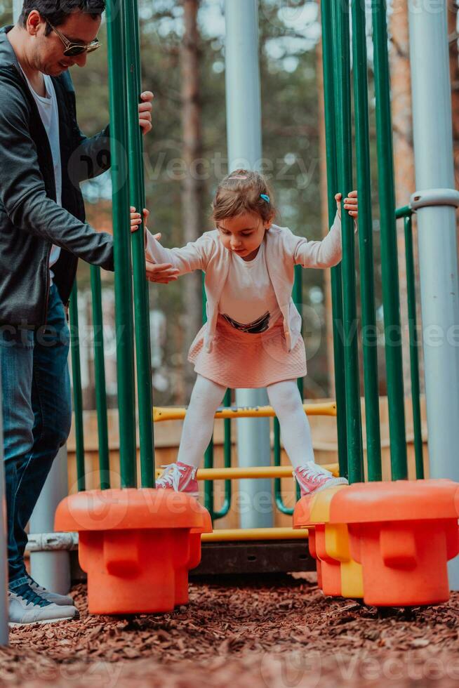 Family time in the park. Father have fun with his daughter in the park, playing fun games and spending time together photo