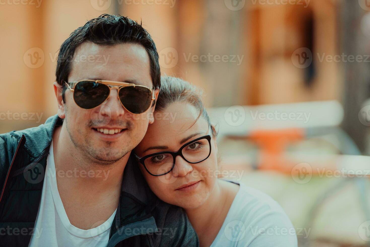 A romantic couple spending time in the park. A couple taking photo on a beautiful sunny day while having a weekend off