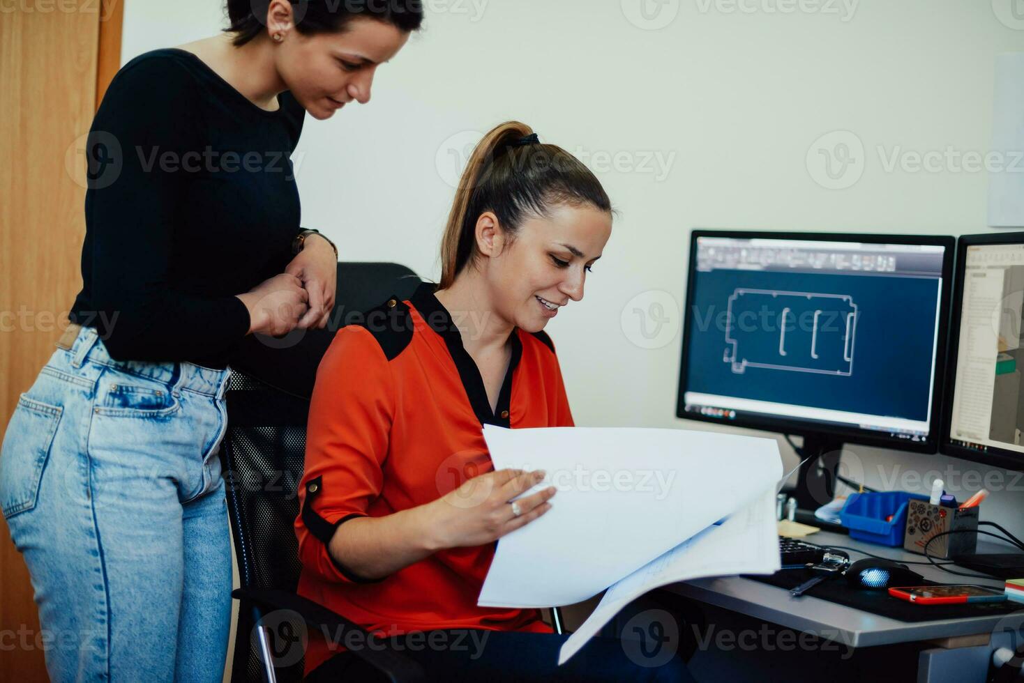 Within the heavy industry, a factory industrial engineer measures with a caliper and on a personal computer Designs a 3D model photo