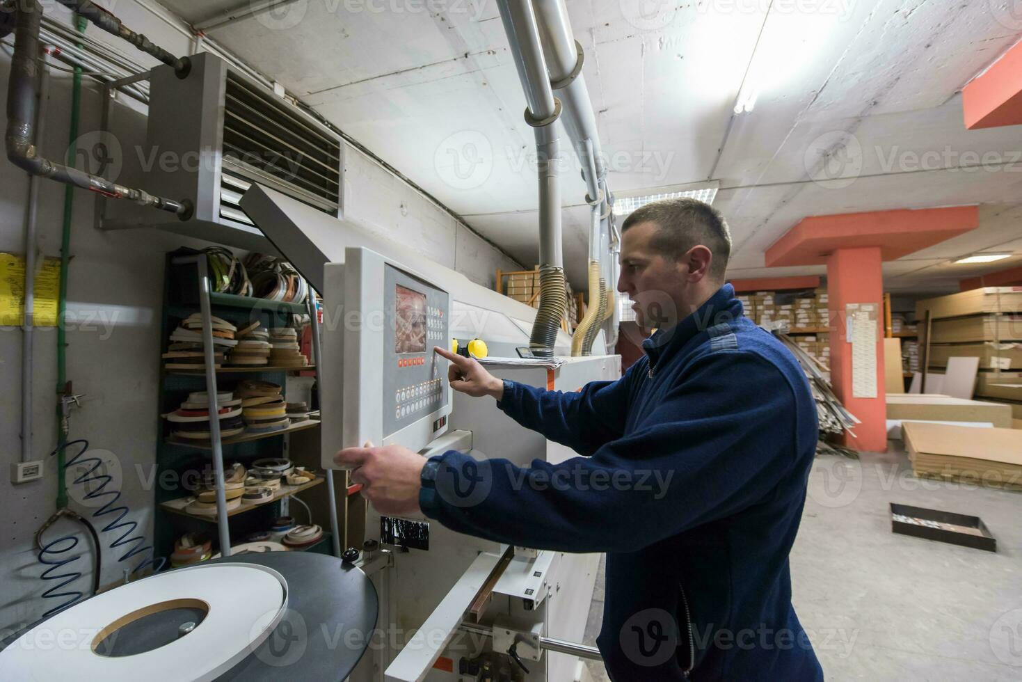 carpenter calculating and programming a cnc wood working machine photo