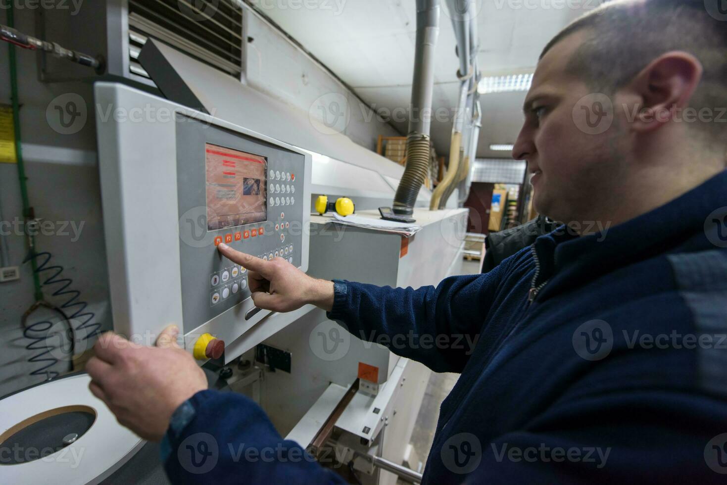 carpenter calculating and programming a cnc wood working machine photo