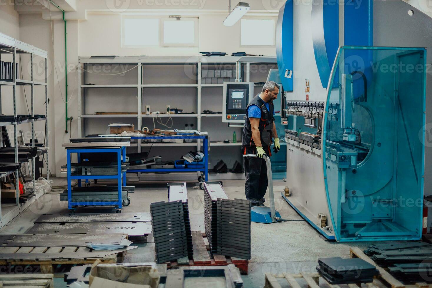 A smart factory worker or engineer makes machines in a production workshop. The concept of industry and engineering. Selective focus photo