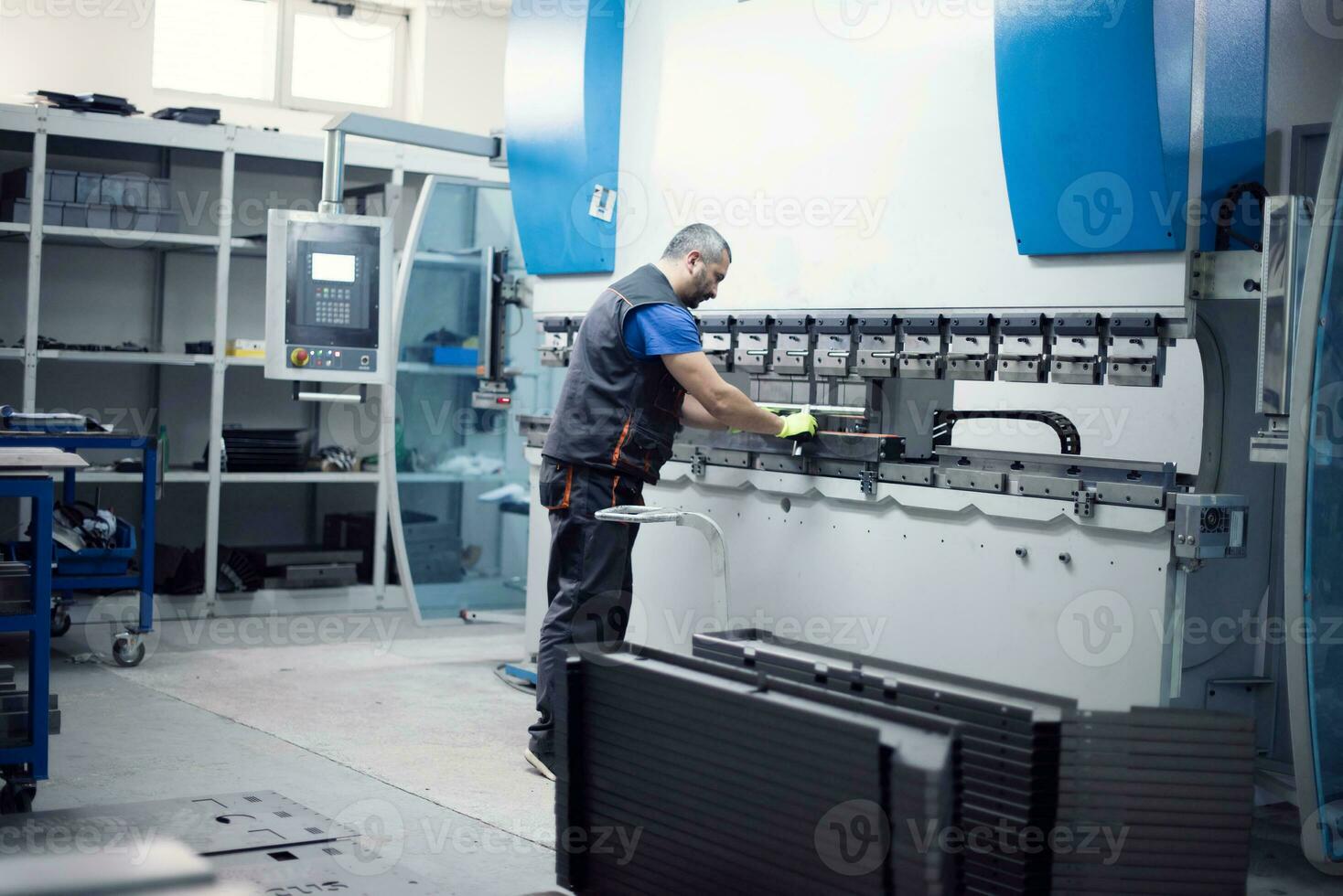 A smart factory worker or engineer makes machines in a production workshop. The concept of industry and engineering. Selective focus photo