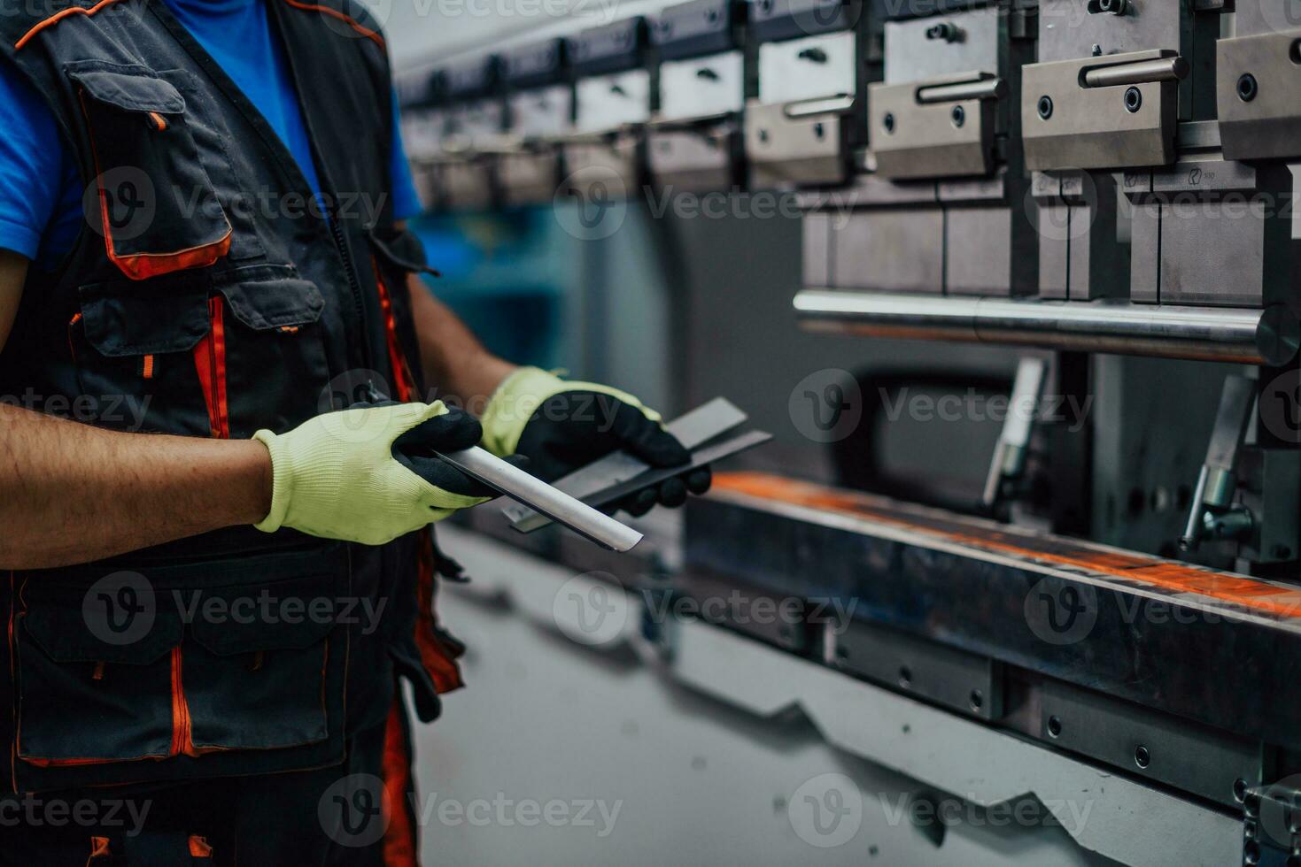 A smart factory worker or engineer makes machines in a production workshop. The concept of industry and engineering. Selective focus photo