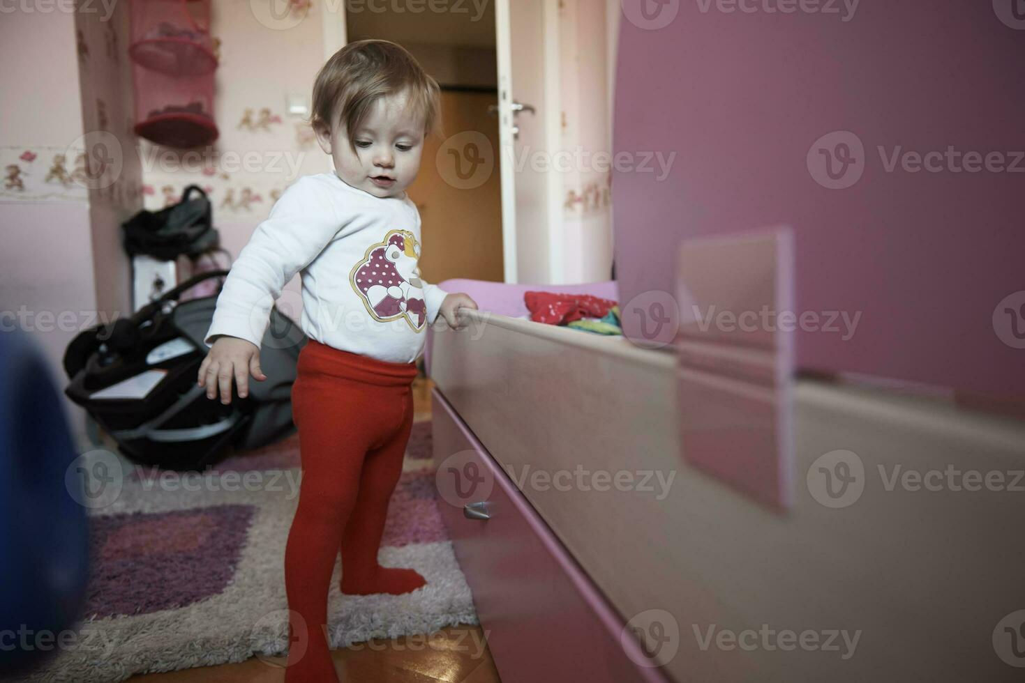 cute  little one year old baby and making first steps photo