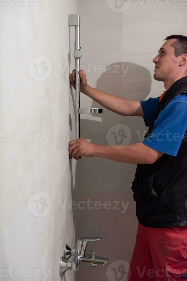 professional plumber working in a bathroom photo