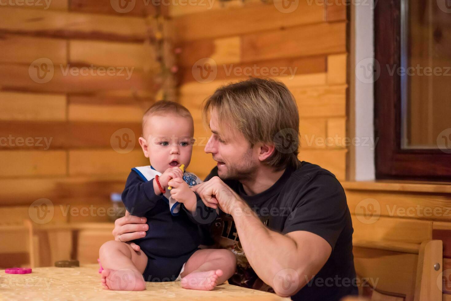 Portrait of young father and his cute baby son photo