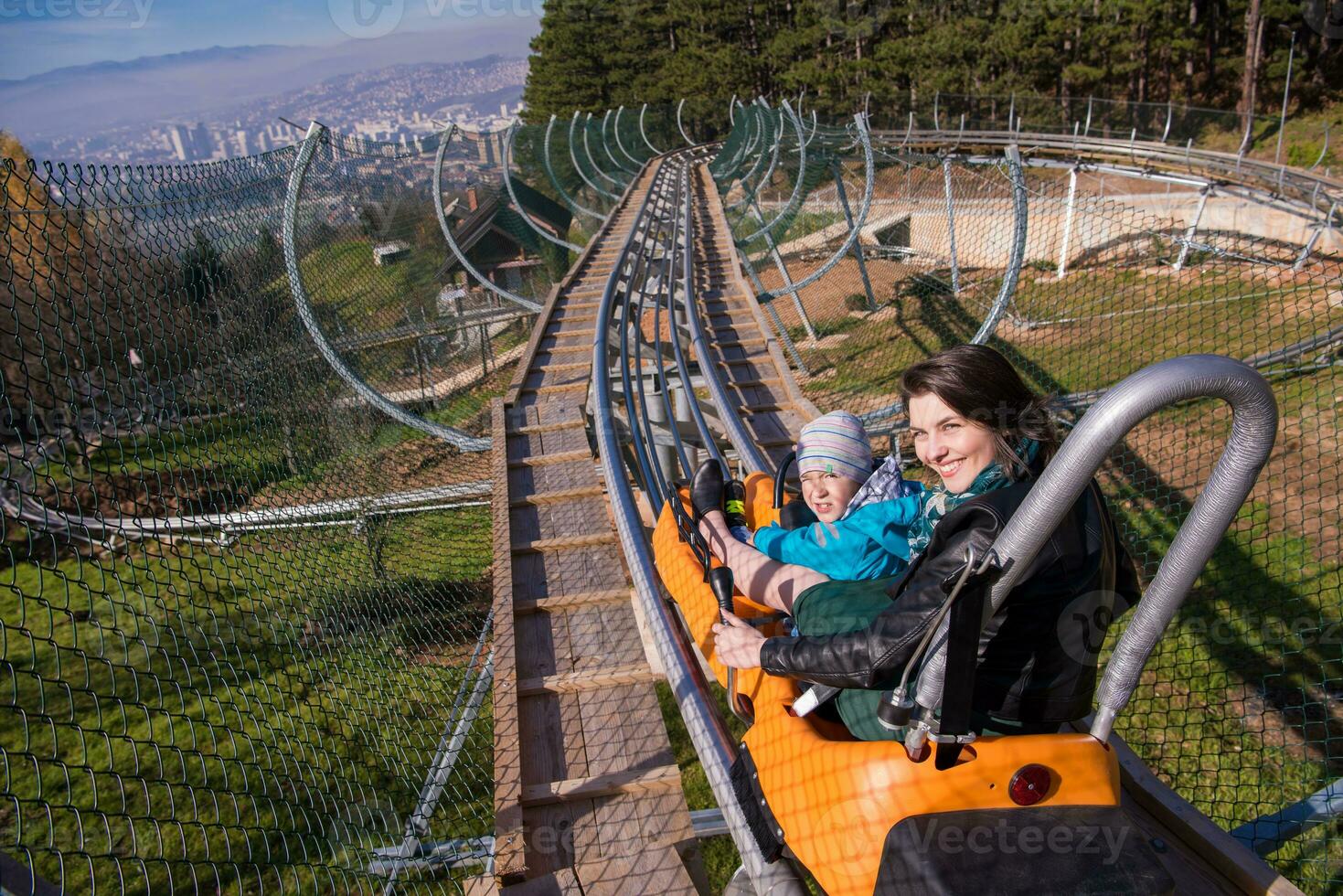 young mother and son driving alpine coaster photo