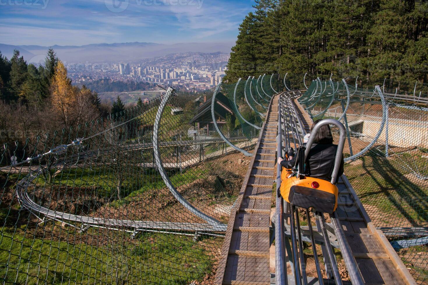 young mother and son driving alpine coaster photo
