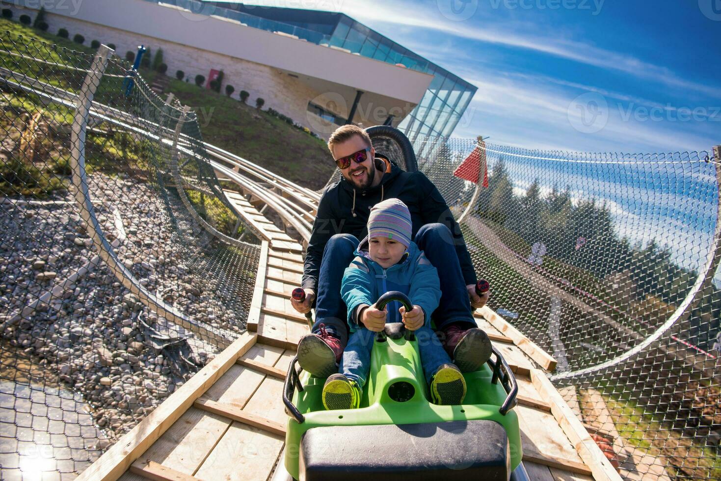 young father and son driving alpine coaster photo
