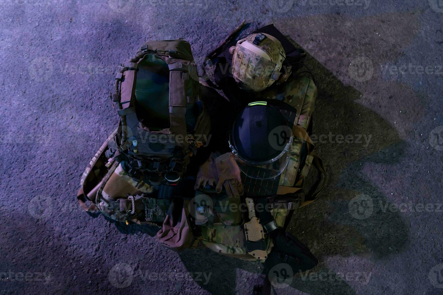 Army body armor, helmet and ammunition, Kalashnikov assault rifle with matrons and first aid tourniquet composition on brown wood. Army body armor. flat laying. military concept. photo