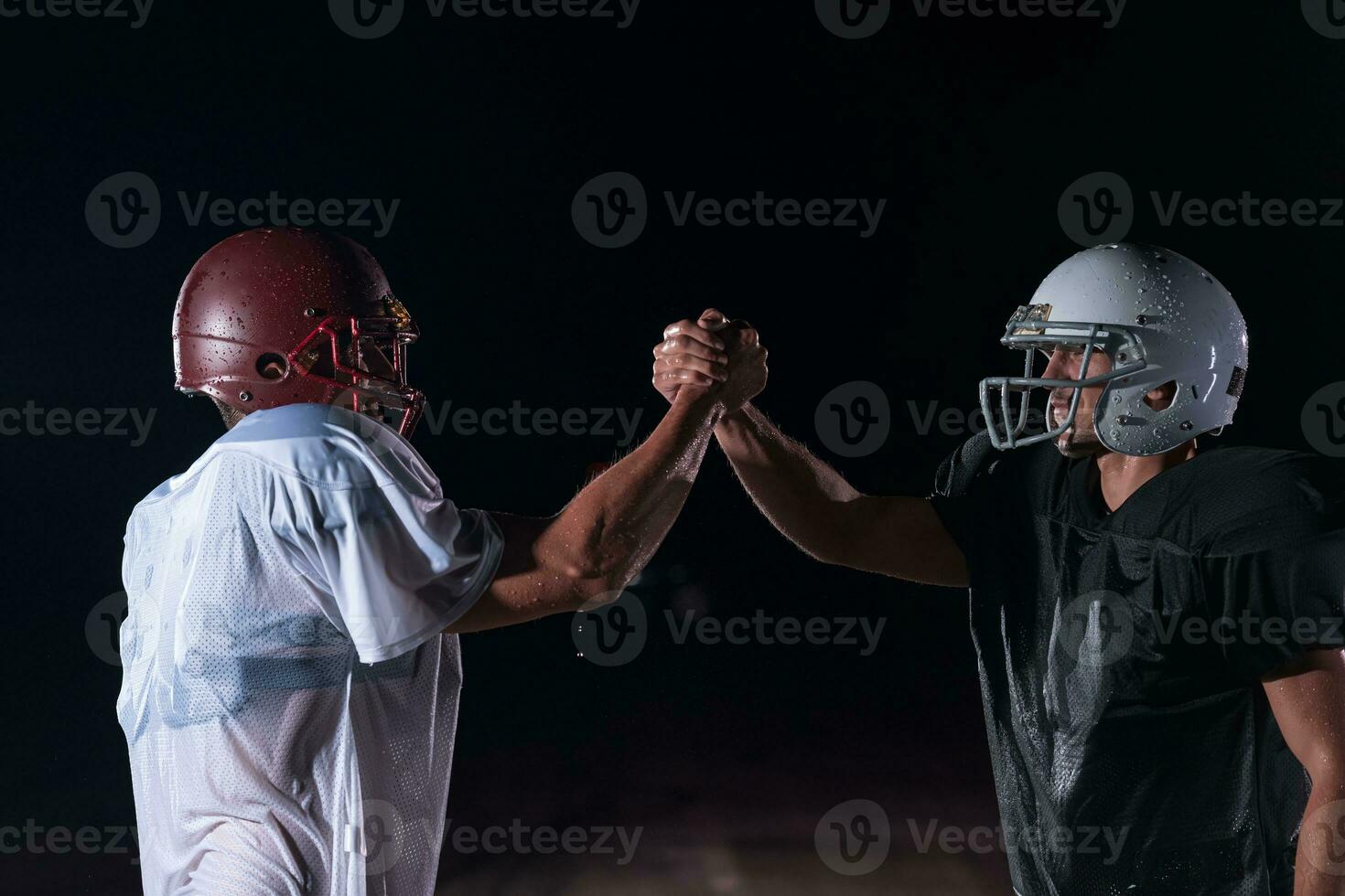 two american football players face to face in silhouette shadow on white background photo