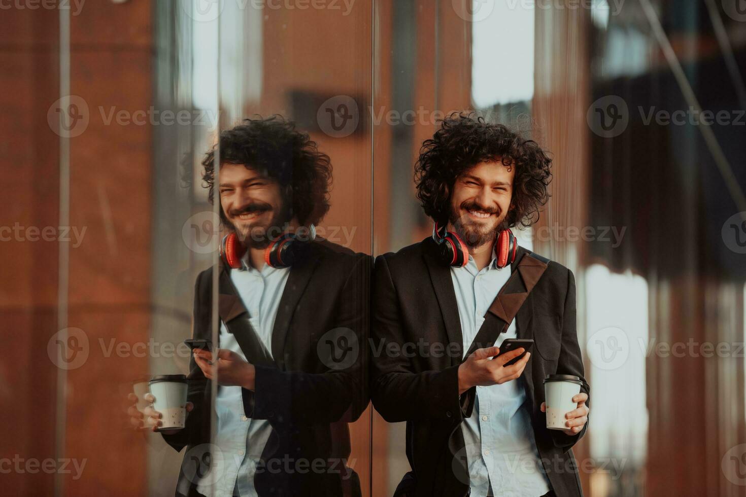 Happy young American holding a coffee. With headphones. Student boy. photo