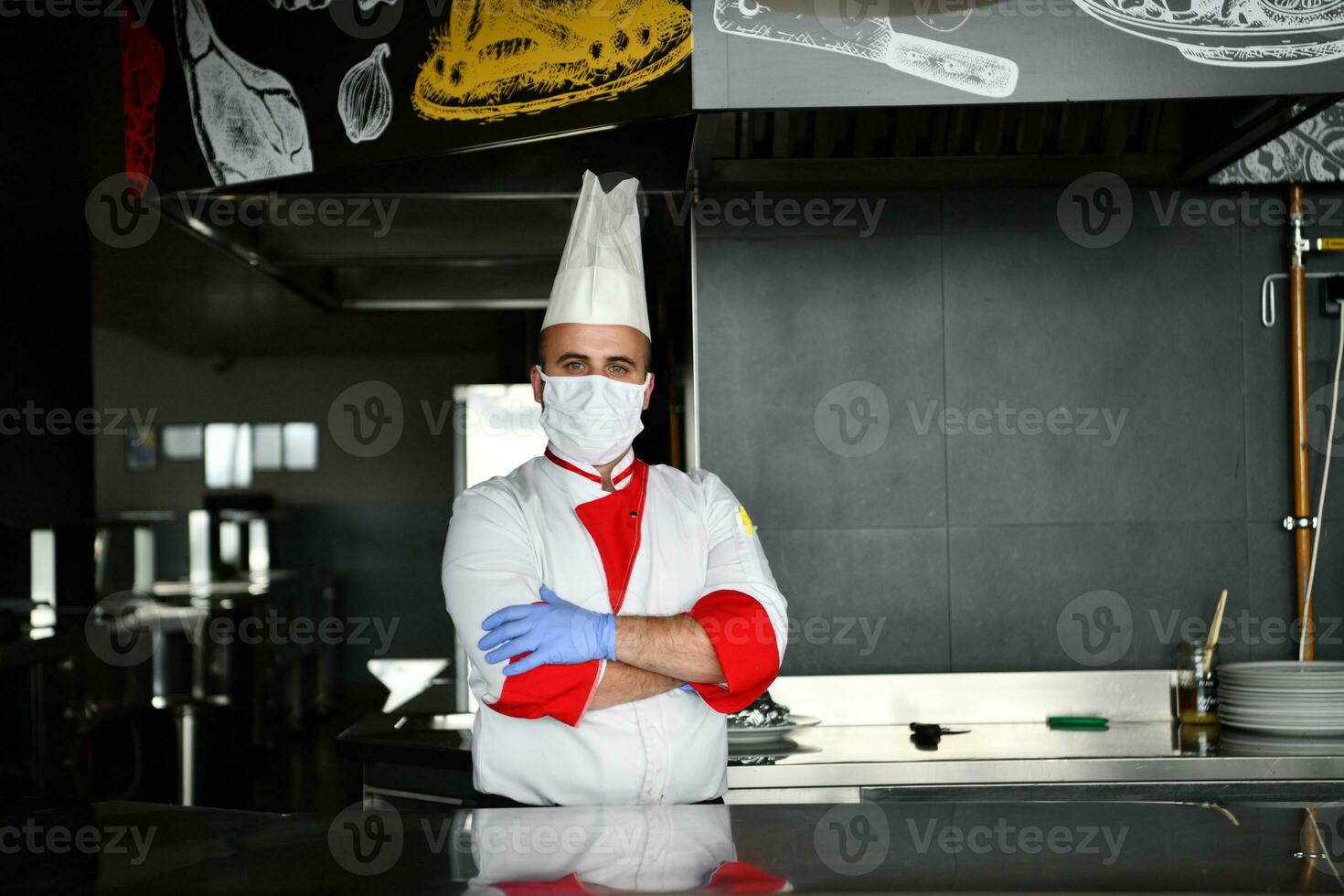 chef cook wearing face protective medical mask for protection from coronavirus photo