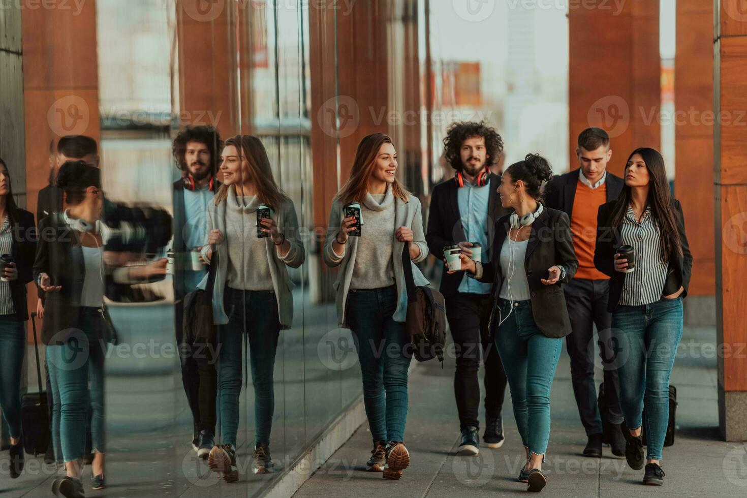 Business colleagues walking and talking on city streets photo