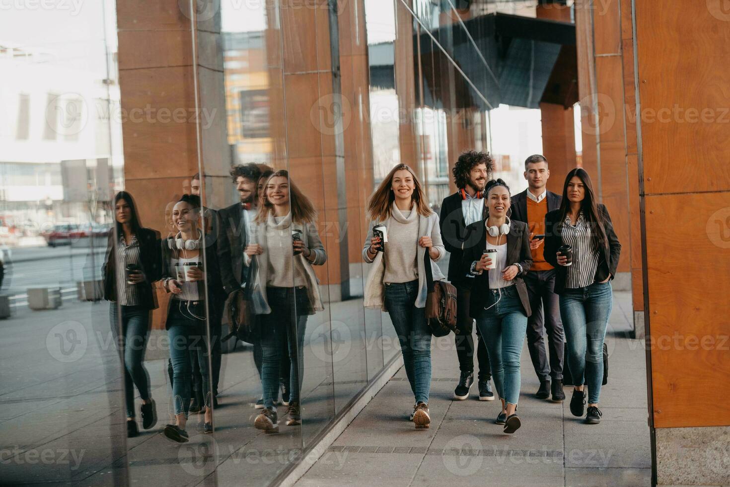 Travelers business team of colleagues walking and talking on modern urban city streets. People on out of the office on break. photo