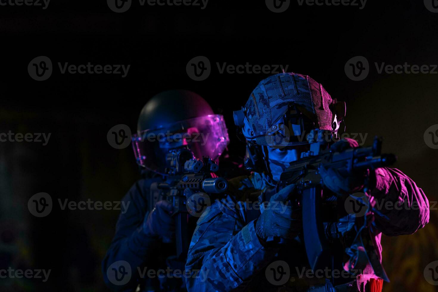 Modern warfare soldiers in dark with combat ammunition and weapons in the hands of equipped laser sights are in battle order. Mixed media. photo