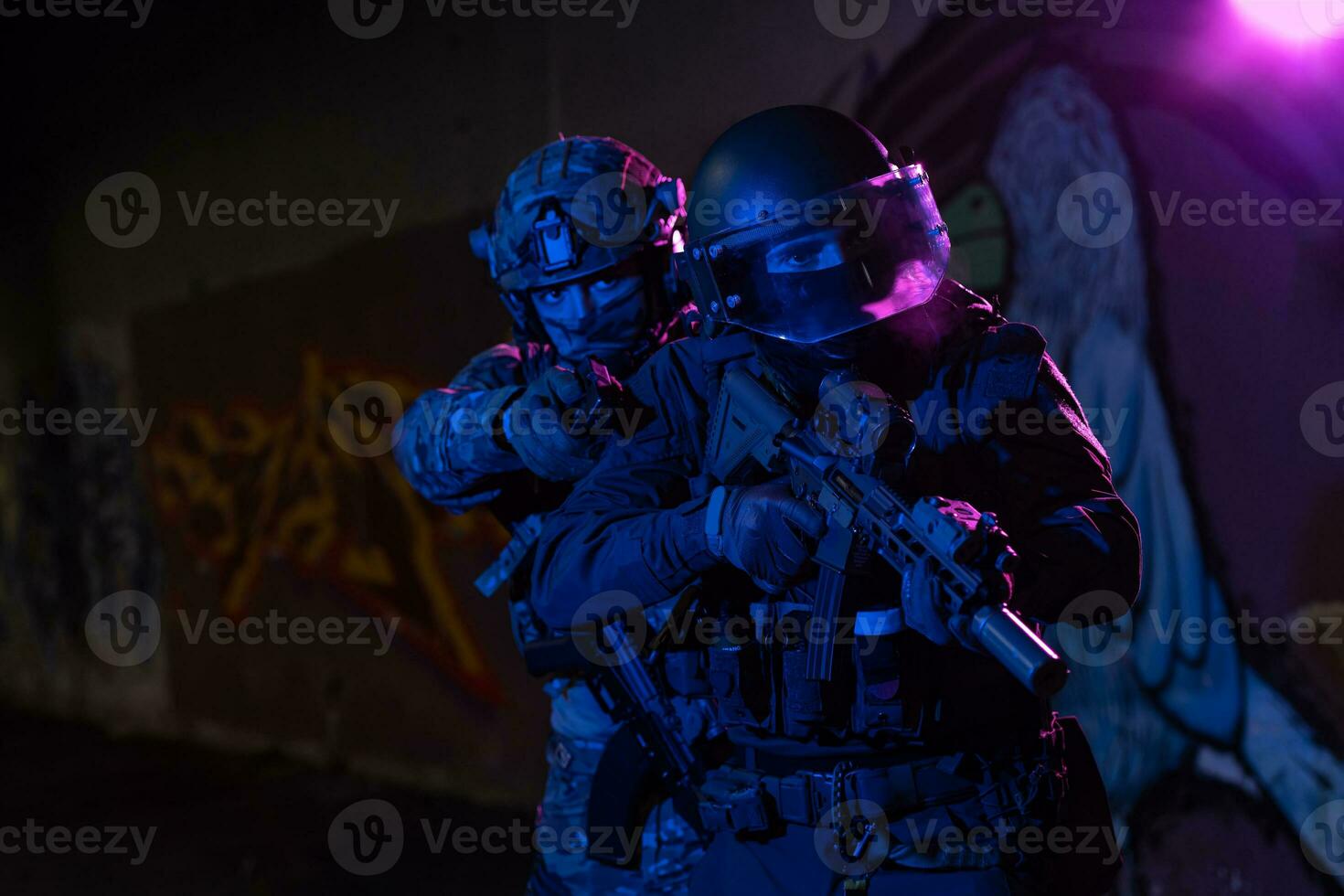 Modern warfare soldiers in dark with combat ammunition and weapons in the hands of equipped laser sights are in battle order. Mixed media. photo