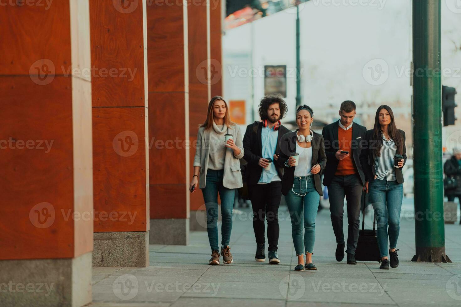Business colleagues walking and talking on city streets photo