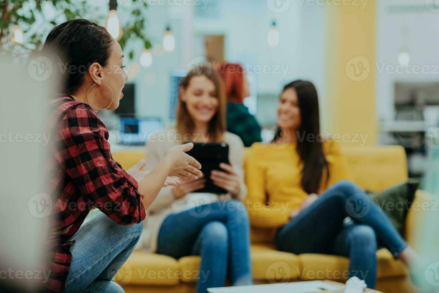 Group of multi-ethnic colleagues working on desktop computers, laptop and sharing their ideas in a modern office space.Young influencers work on online marketing projects. photo