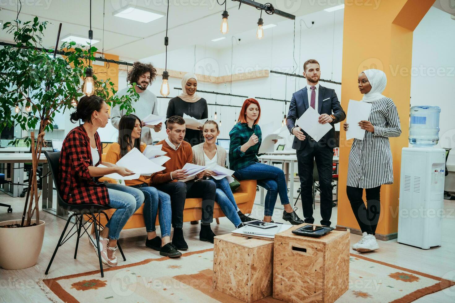 Group of multi-ethnic colleagues working on desktop computers, laptop and sharing their ideas in a modern office space.Young influencers work on online marketing projects. photo