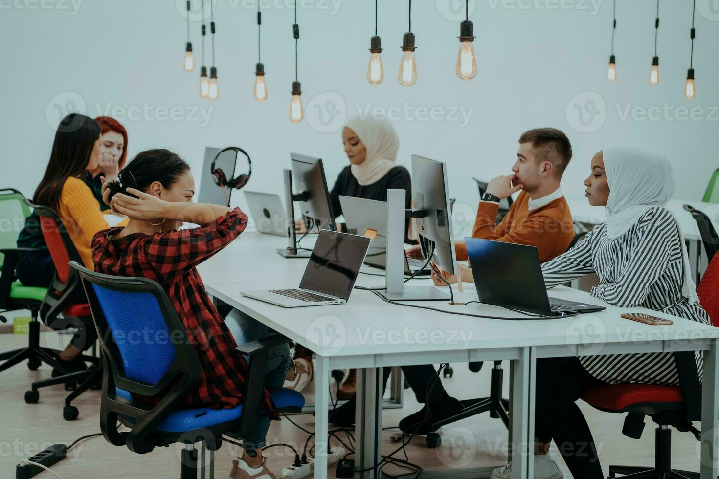 Multiethnic group of employees working in a marketing company. A group of colleagues is working on a project in modern offices photo