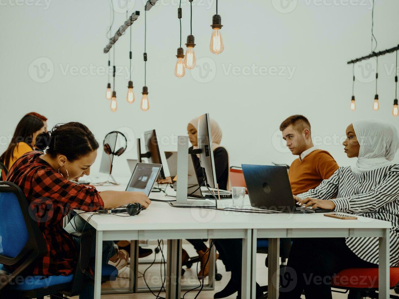 Multiethnic group of employees working in a marketing company. A group of colleagues is working on a project in modern offices photo