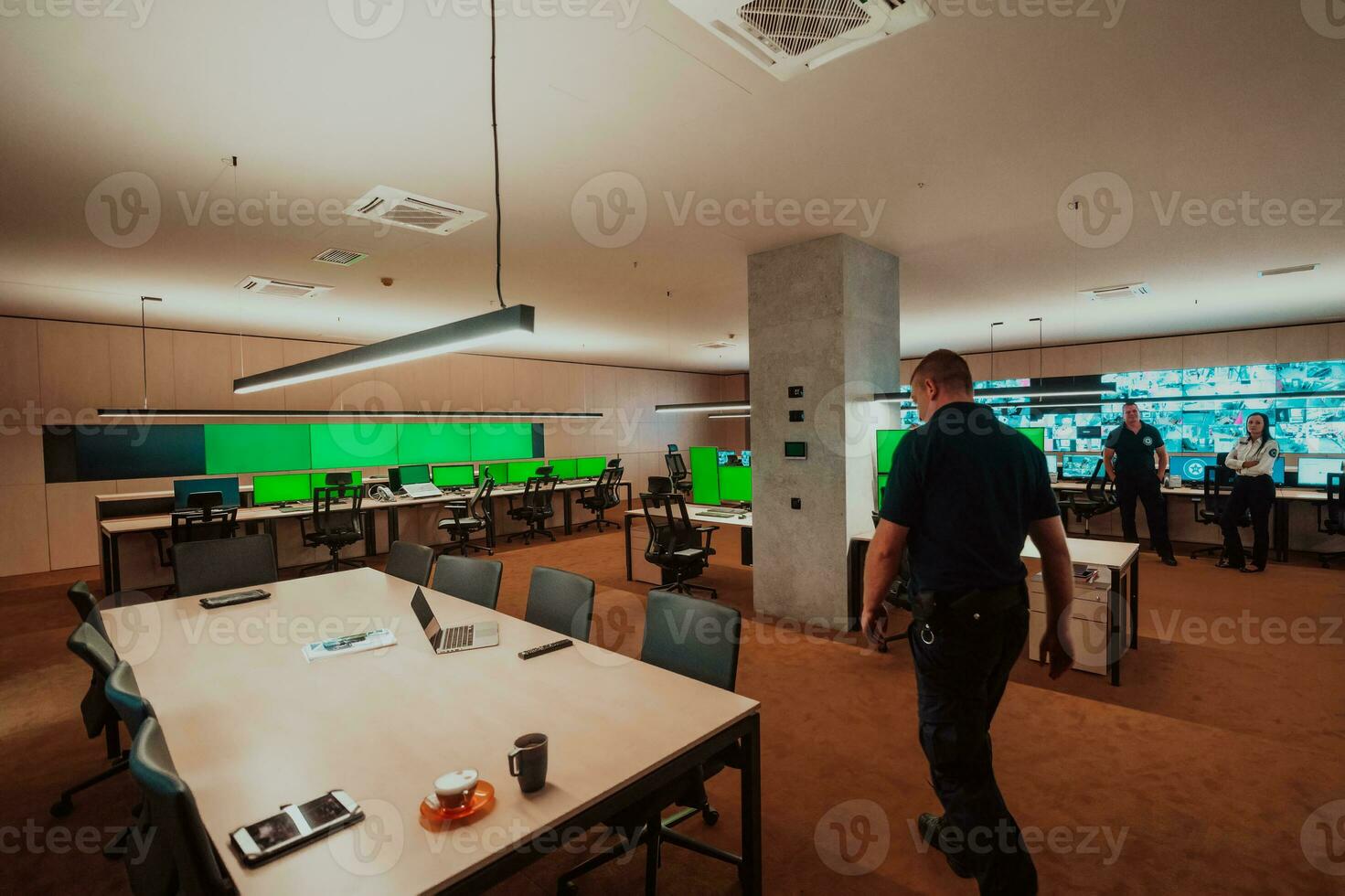 Group of Security data center operators working in a CCTV monitoring room looking on multiple monitors Officers Monitoring Multiple Screens for Suspicious Activities Team working on the System Contr photo