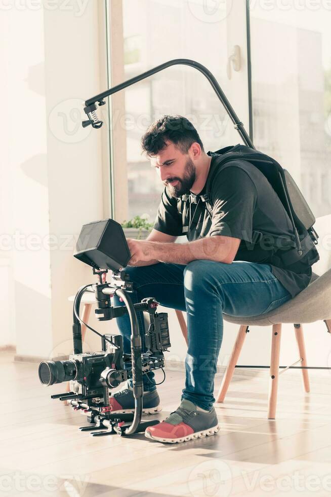 Video operator. Videography.Filming.A man is shooting a video.The work of a videographer. Shooting with a professional camera with a tripod. A man shoots on a professional video camera.Videographer photo