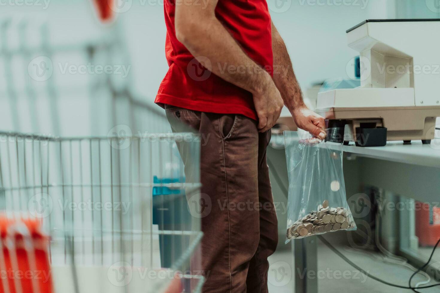 Bank employees using money counting machine while sorting and counting small iron banknotes inside bank vault. Large amounts of money in the bank photo