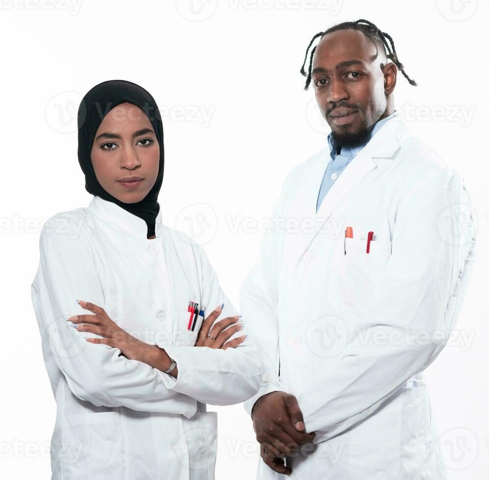 Closeup front view of group of mixed age doctors and nurses standing side by side and looking at the camera. Young Middle Eastern female in a team with African American male doctor. photo