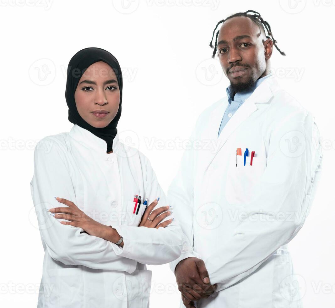 Closeup front view of group of mixed age doctors and nurses standing side by side and looking at the camera. Young Middle Eastern female in a team with African American male doctor. photo