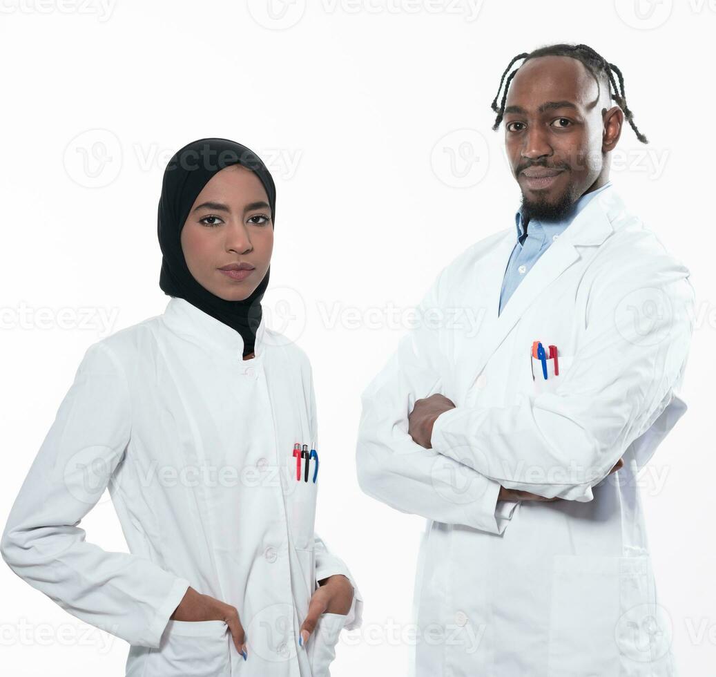 Closeup front view of group of mixed age doctors and nurses standing side by side and looking at the camera. Young Middle Eastern female in a team with African American male doctor. photo