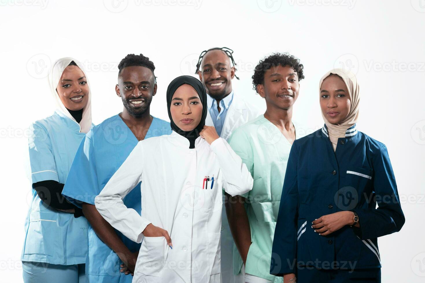 Team or group of a doctor, nurse and medical professional coworkers standing together. Portrait of diverse healthcare workers looking confident. Middle Eastern and African, Muslim medical team. photo