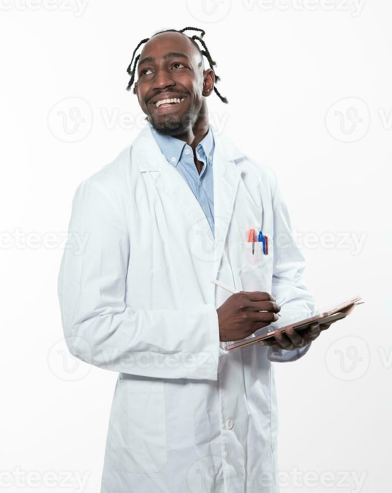 Doctor dark skin guy virologist agent corona virus seminar conference arms crossed pandemic virus expert wear white lab coat isolated white color background using a tablet computer. photo