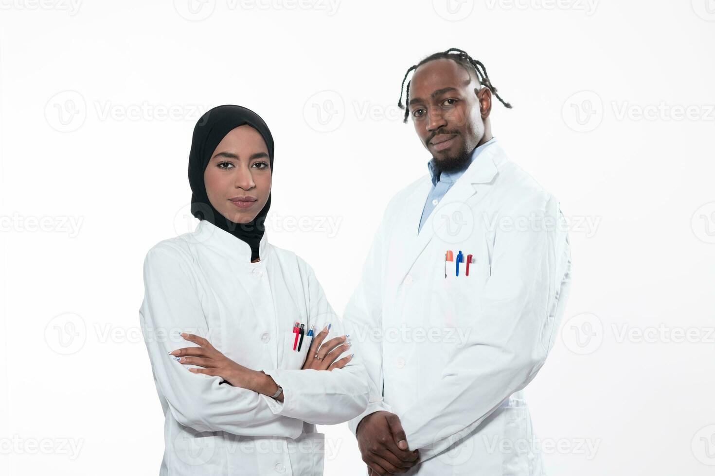 Closeup front view of group of mixed age doctors and nurses standing side by side and looking at the camera. Young Middle Eastern female in a team with African American male doctor. photo
