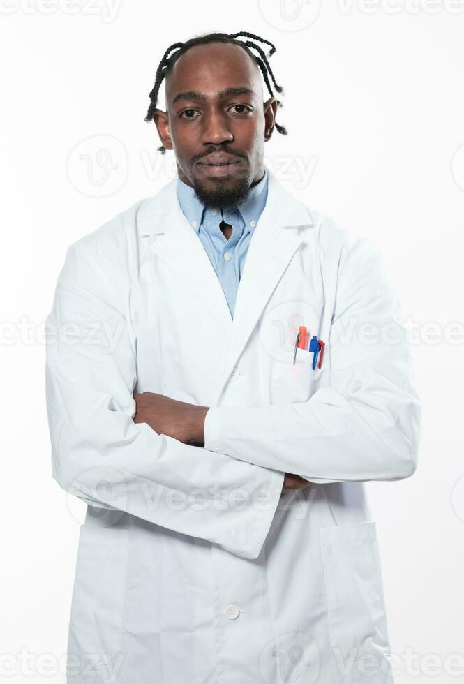 Doctor dark skin guy virologist agent corona virus seminar conference arms crossed pandemic virus expert wear white lab coat isolated white color background using a tablet computer. photo
