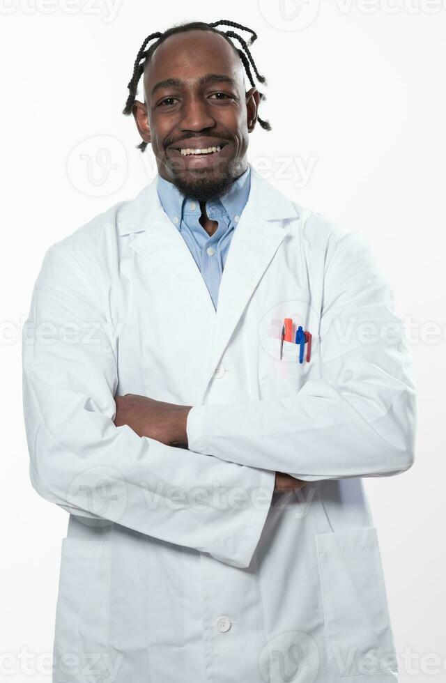 Doctor dark skin guy virologist agent corona virus seminar conference arms crossed pandemic virus expert wear white lab coat isolated white color background using a tablet computer. photo