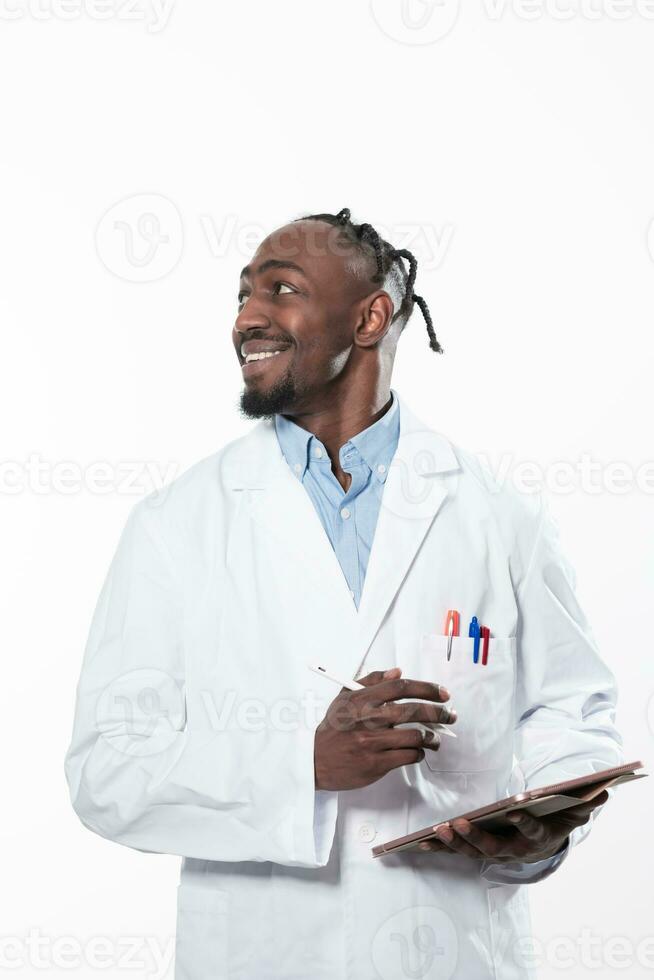 Doctor dark skin guy virologist agent corona virus seminar conference arms crossed pandemic virus expert wear white lab coat isolated white color background using a tablet computer. photo