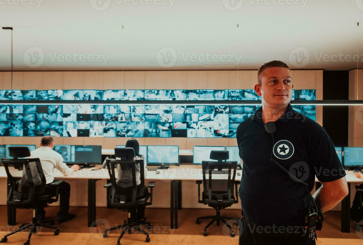 Male security operator working in a data system control room offices Technical Operator Working at workstation with multiple displays, security guard working on multiple monitors Male computer opera photo