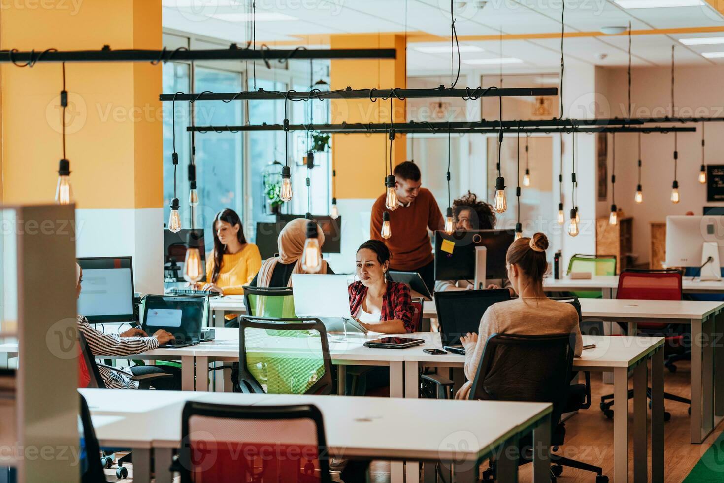 Multiethnic group of employees working in a marketing company. A group of colleagues is working on a project in modern offices photo