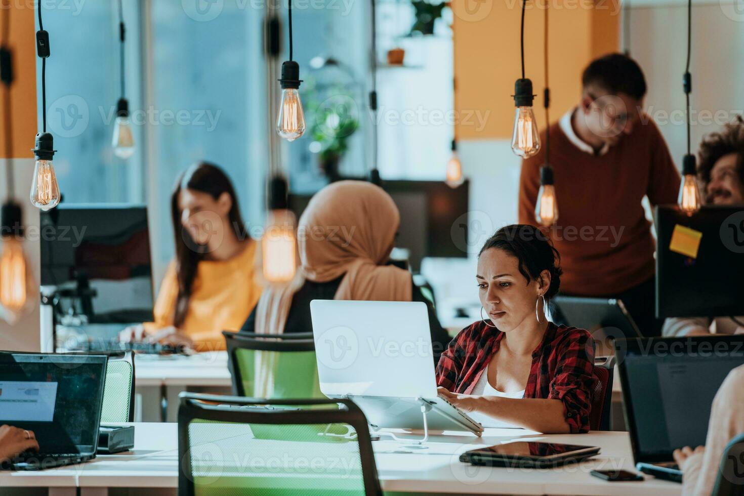 Multiethnic group of employees working in a marketing company. A group of colleagues is working on a project in modern offices photo