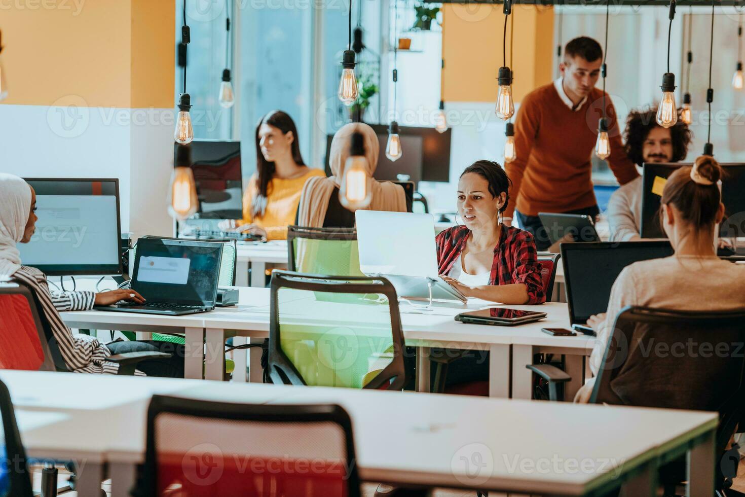 Multiethnic group of employees working in a marketing company. A group of colleagues is working on a project in modern offices photo